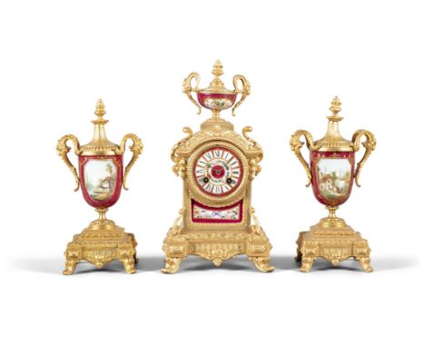 A FRENCH GILTMETAL AND PORCELAIN MOUNTED THREE PIECE GARNITURE SET, 19TH CENTURY comprising a mantle clock and matching urns,