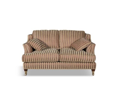 A STRIPED TWO SEATER SOFA upholstered in a cream and red fabric, with loose seat cushions, on timber and brass block feet. 81