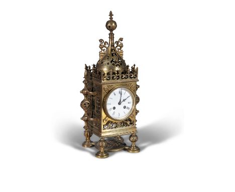 A FRENCH GOTHIC REVIVAL BRASS CASED MANTLE CLOCK LATE 19TH CENTURY, with pierced dome mount above a circular white enamel dia