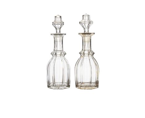 A PAIR OF CUT GLASS DECANTERS AND STOPPERS,triple ring necked, with diamond cut bodies, mushroom stoppers each 27cm high; tog