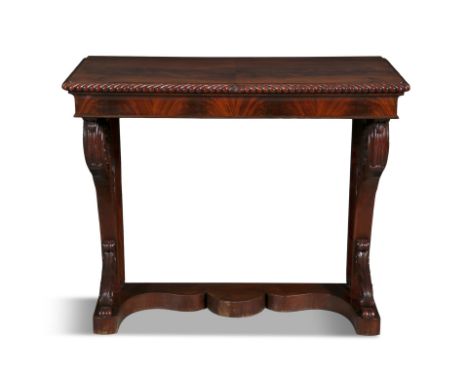 AN EARLY VICTORIAN CARVED MAHOGANY CONSOLE TABLE CIRCA 1840with solid panel top, gadrooned rim, above a cavetto flame mahogan