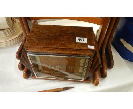 A Hendersons Art Deco style mantel clock with key and pendulum