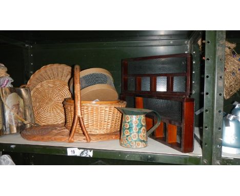 A shelf of wicker ware and wooden trays