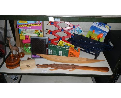 A shelf of miscellaneous including wooden crocodile, wooden items, coat rack etc