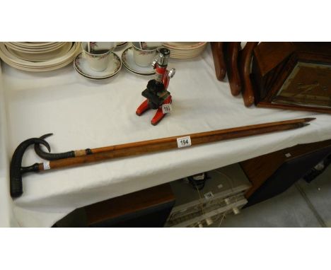 2 walking sticks with horn handles and writing to stick