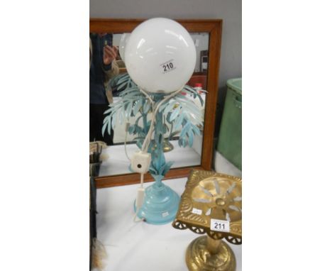 A globed topped lamp with metal floral and leaf lamp base