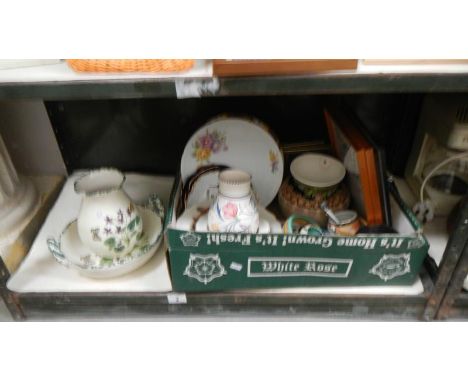 A shelf of pottery including Poole and Royal Doulton