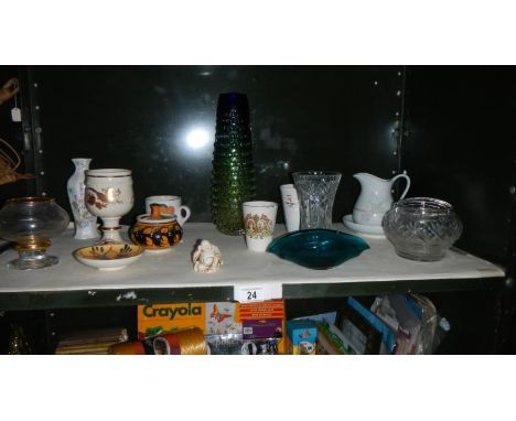 A shelf of pottery and glass