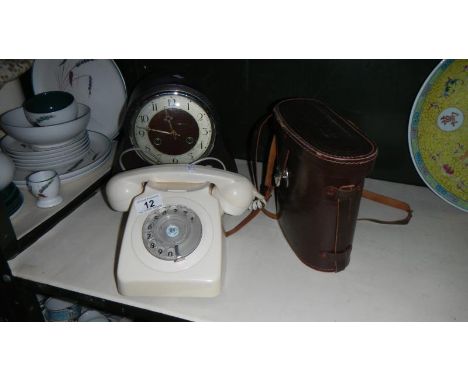 A vintage telephone, pair of Telemax binocular and a mantel clock