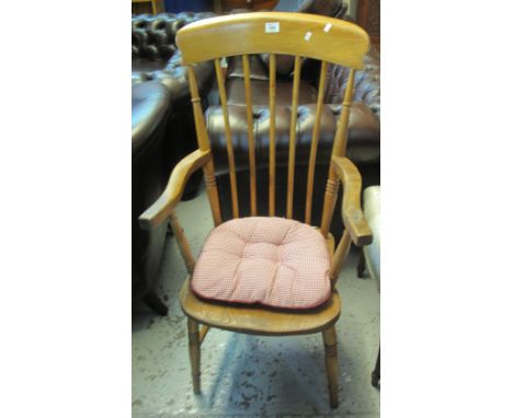 20th Century beech and elm stick backed fireside elbow chair with loose cushion.(B.P. 24% incl. VAT)