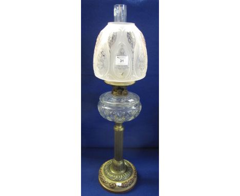 Early 20th Century brass double burner oil lamp with cut glass reservoir on brass pedestal base having frosted shade and clea