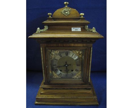 Early 20th Century oak architectural gilt metal mounted two train mantle clock with German brass movement.48cm high.  Include