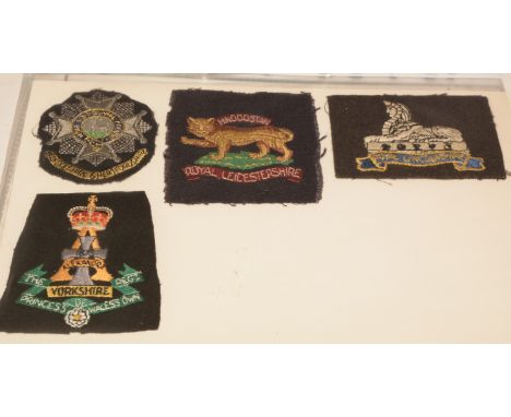 A collection of approximately 50 Military cloth badges and Regimental embroideries, to include: Bedfordshire &amp; Hertfordsh