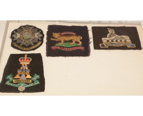 A collection of approximately 50 Military cloth badges and Regimental embroideries, to include: Bedfordshire &amp; Hertfordsh