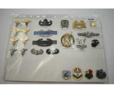 A collection of 24 American metal Insignia badges, to include: Medical Specialist Corps, Army Nursing Corps, Dental Corps, Me