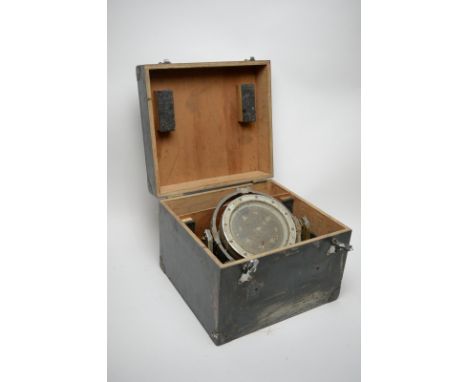 A ship's compass, the 18cms grey painted steel case on gimbal mount.