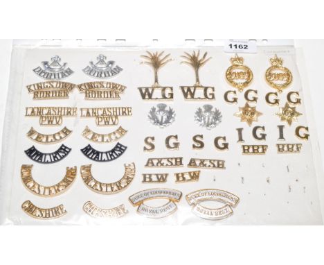 A collection of 18 pairs of Military shoulder titles, to include: Durham Light Infantry, King's Own Borderers, Welch, Royal I