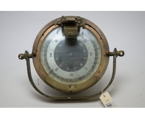 A ship's compass, in 25.5 weatherproof brass casing, fitted prism sight, on swivel mount.