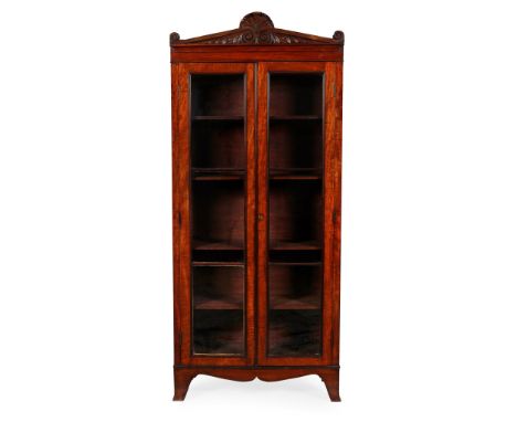 LATE REGENCY MAHOGANY BOOKCASE   EARLY 19TH CENTURY with shell and foliate cornice, over a pair of glazed panel doors enclosi