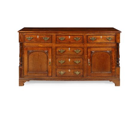 Y LATE GEORGE III OAK DRESSER BASE   EARLY 19TH CENTURY the rectangular top above three frieze drawers and two carved panel c
