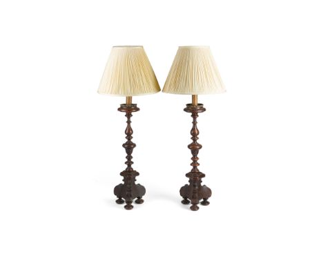 PAIR OF CONTINENTAL FRUITWOOD PRICKET STICK LAMPS   18TH CENTURY converted to lamps; with pleated shades(67cm high, excluding