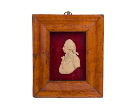 FOUR RELIEF PORTRAIT ROUNDELS comprising: three wax relief portraits; and a three-quarter profile, possibly glass paste