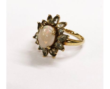 Ladies 9ct Gold Opal &amp; Aquamarine? Ring, with central oval cabochon opal &amp; 14 shaped pale blue stones, fully hallmark