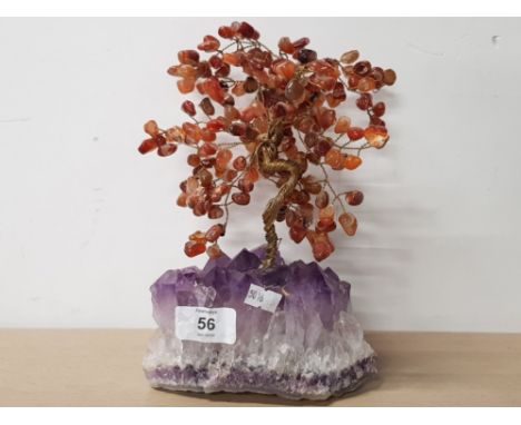 AN AMETHYST QUARTZ BASE WITH A WIREWORK TREE COVERED IN POLISHED AMBER GEMSTONES AS LEAVES