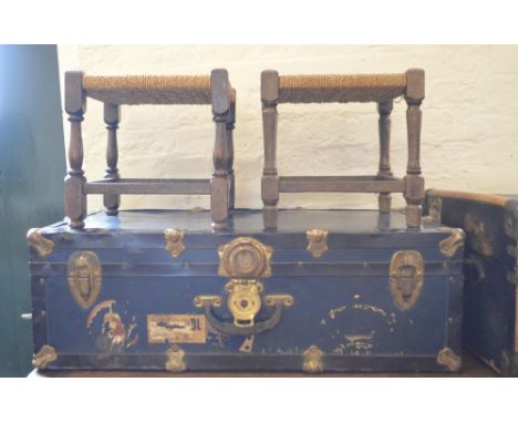 A bound travel chest and a metal mounted bound travelling trunk and two stools
