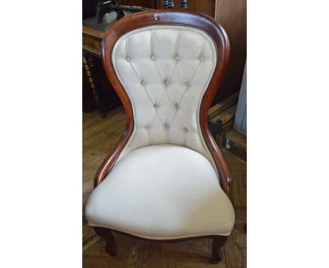 A cream button back upholstered lady's chair by Stuart Jones 