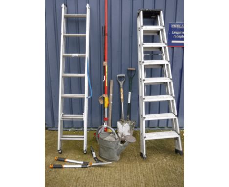 An aluminium extending ladder, aluminium folding stepladder and assorted long-handled tools, together with a watering can