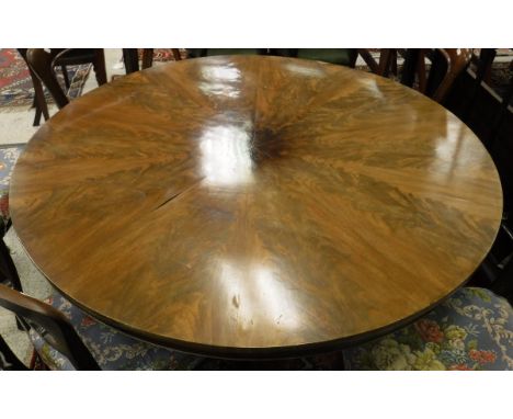 A Victorian mahogany breakfast table, the segmented top of figured mahogany on a tapering turned pedestal to tripod platform 