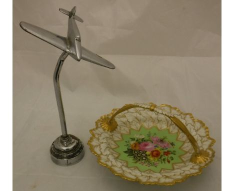 A chrome ornament of a Spitfire, raised on a cylindrical column and turned base, together with a Flight and Barr Worcester po