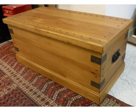 A pine and iron bound and studded trunk on a plinth base