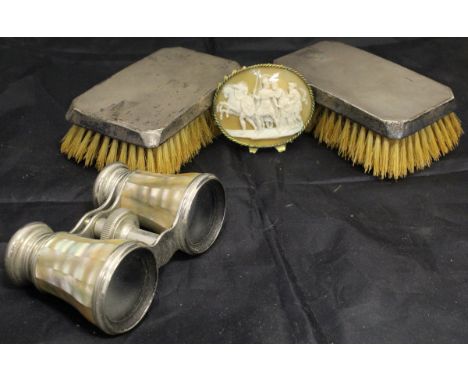 A pair of silver mounted hairbrushes, together with a pair of mother of pearl mounted opera glasses and a cameo style plaque 