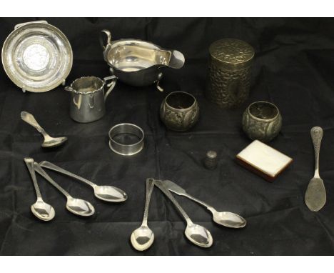 A collection of silver and silver plated wares to include a sauceboat in the George III taste, a cream jug with applied decor