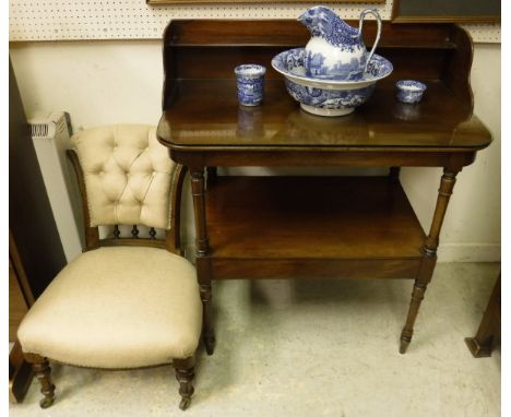 A 19th Century two tier mahogany wash stand with galleried top encompassing a shelf, rounded corners on turned supports to th