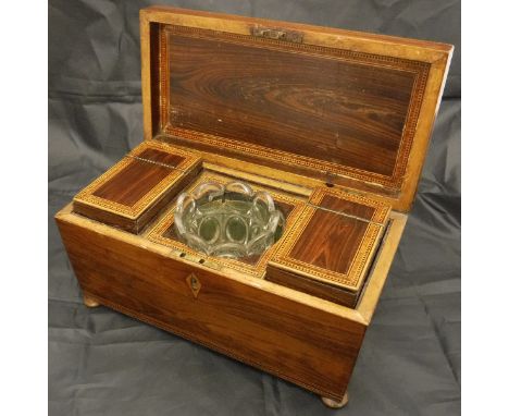 A Victorian rosewood and parquetry inlaid tea caddy of sarcophagus form, the top opening to reveal a central recess with asso