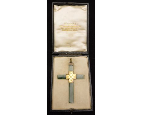 A jade and gilt metal mounted pendant in the form of a cross, housed in a fitted box inscribed "Norris Watchmaker & Jeweller 