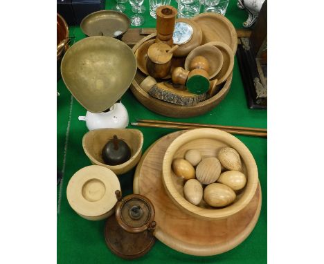 Assorted treen wares to include eggs, bowls, candlestick, etc and a set of scales