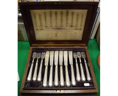 A Victorian silver 12 place fish knife and fork set with filled handles (by JRM over EW in italics within a shield shaped pun