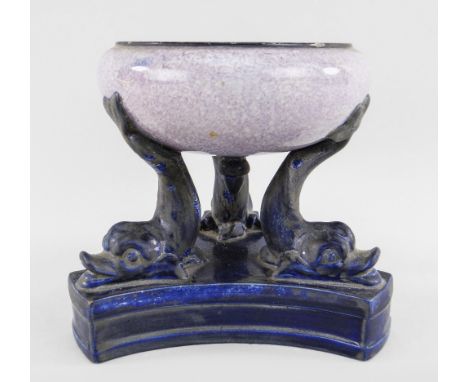 A RARE SWANSEA EARTHENWARE DOLPHIN-SUPPORT PASTILLE BURNER on curved triangular base, the base and three dolphins glazed in d