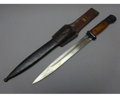 German Bayonet, 25cm blued steel single edge fullered blade with ricasso stamped Coppel GmbH, 7807 over f, wooden slab grip, 