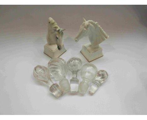 Two Royal Worcester figures of horses heads and five decanter stoppers
