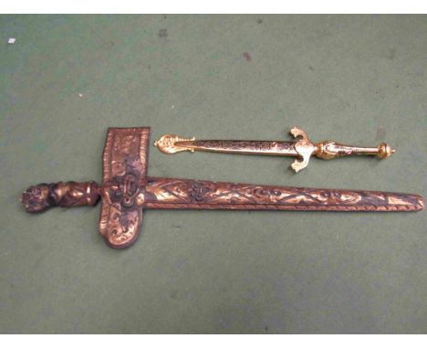 A decorative Malaysian Kris knife with carved gilt wood scabbard and a repro Spanish dagger