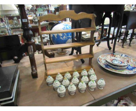 A Franklin Mint spice rack and sixteen porcelain containers