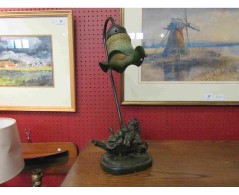 A figural lamp as a girl in a wheelbarrow, with fitted shade, 43cm tall    