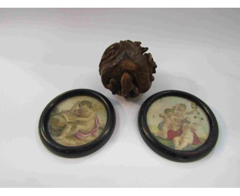 An Oriental carved wooden dragon paperweight and two small framed prints of cherubs