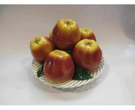 A Majolica style ceramic table centrepiece of apples in a lattice basket    