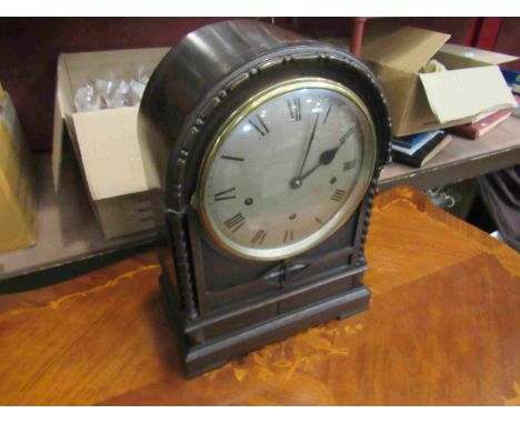 A late 19th/early 20th Century carved oak bracket clock of arched form with twisted supports, silvered convex Roman dial, thr